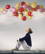 balloons floating over woman